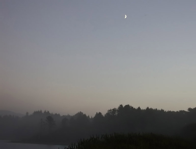 quarter moon over foggy valley - south of crescent city, california