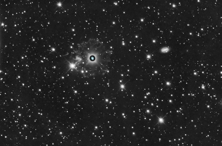 The Cat's Eye Nebula - NGC 6543, with surrounding nebulosity. The galaxy on the right is NGC 6552.